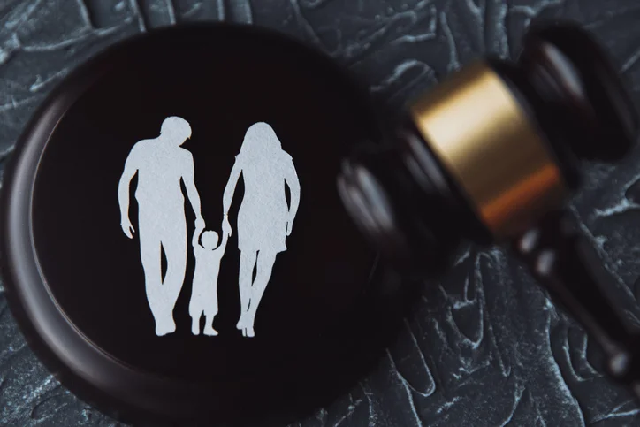 family paper cutout and a gavel