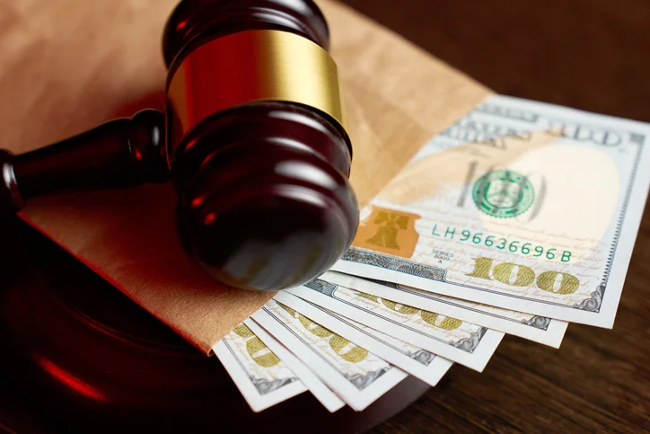 a gavel and an envelope of money